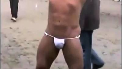 Asian bodybuilder barely covered at the beach - nvdvid.com