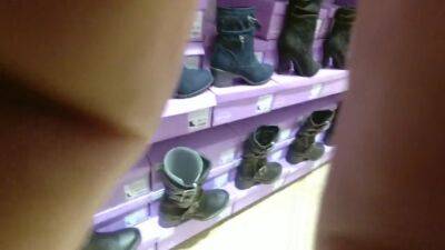 Trying heels and boot in a store - voyeurhit.com