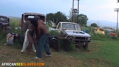 Masked Black Bitch Whipped and Banged in Public Junkyard by Two Cocks - txxx.com