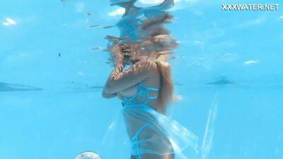 Her Body Cutting Through The Shimmering Water Of The Pool - upornia.com